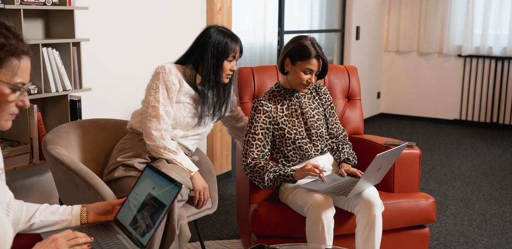 people looking at a laptop working